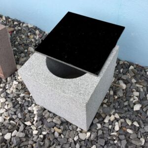 A black square on top of a concrete block.