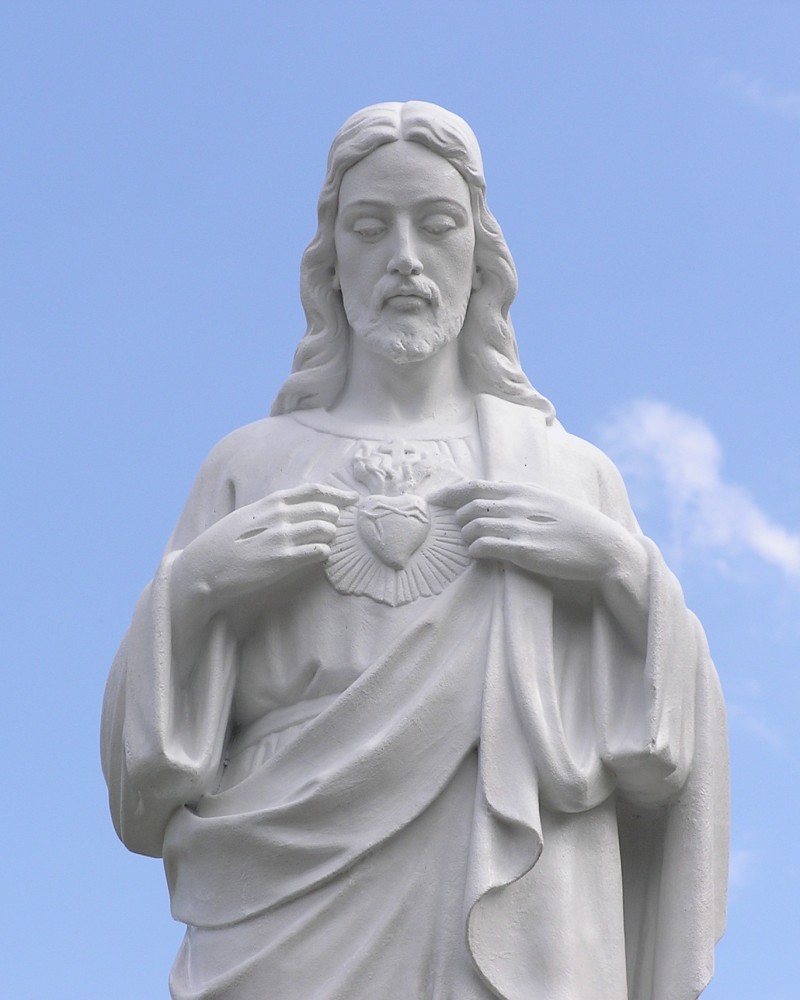 A statue of jesus holding the heart in his hands.