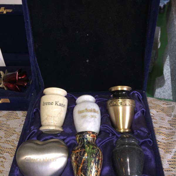 A box of four different urns in it.