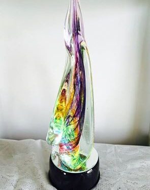 A glass sculpture of a colorful abstract design.