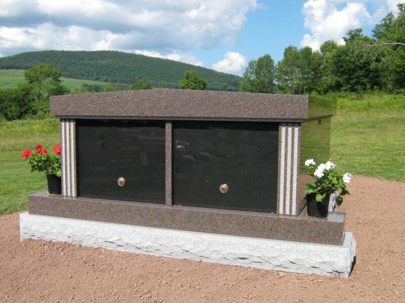 A large granite memorial with two windows.