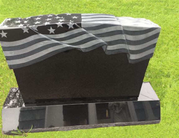 A computer generated image of an american flag draped over the top of a grave.